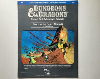 May include: A Dungeons & Dragons Expert Set Adventure Module cover with a black background and a colorful illustration of a desert scene. The title is "Master of the Desert Nomads" by David Cook. The text "The 1st module in the DESERT NOMADS series" is also visible.