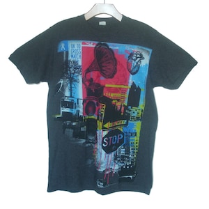 May include: A dark gray t-shirt with a colorful graphic print featuring a vintage gramophone, a heart, a stop sign, and the text "OK to cross watch".