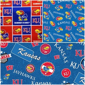 May include: Fabric with multiple patterns featuring the University of Kansas Jayhawks. Designs include the KU logo, the Jayhawk mascot, and the word "Kansas" in various arrangements. The color scheme is primarily blue, red, and yellow.