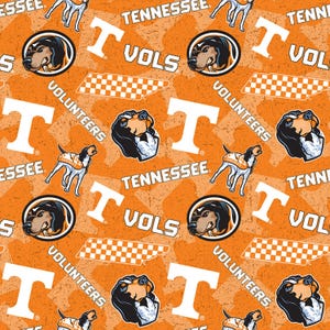 May include: Orange and white patterned fabric featuring the University of Tennessee Volunteers. The design includes the letter "T", the words "Tennessee" and "Vols", a hound dog, and a checkered pattern.