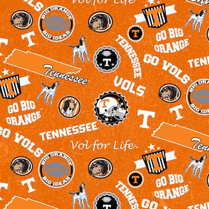 May include: Orange fabric with a repeating pattern of Tennessee Volunteers imagery. The design includes the words "Tennessee", "Go Big Orange", "Vols", and "Vol for Life", along with football helmets, hound dogs, and the letter "T".