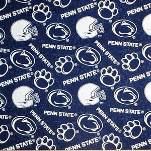 May include: Navy blue fabric with a repeating pattern of white Penn State logos, football helmets, and paw prints. The words "PENN STATE" are also printed on the fabric. The fabric is measured in inches.
