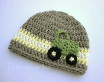 May include: A gray crocheted hat with a yellow and white stripe and a green crocheted tractor applique.