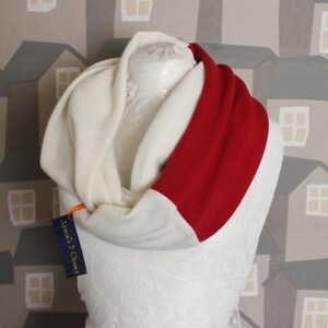 May include: A white and red infinity scarf with a tag that says "Anna's Closet".