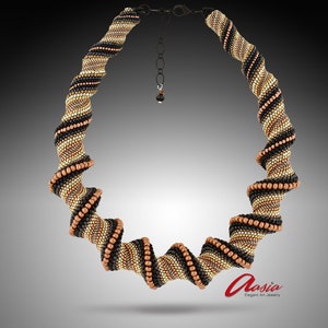 May include: A black, gold, and copper beaded necklace with a spiral design. The necklace is made of small beads and has a clasp closure. The necklace is on a white background.