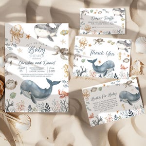 May include: A set of baby shower invitations and cards with an ocean theme. The invitations feature watercolor illustrations of whales, dolphins, and other sea creatures. The text includes the names Christine and Daniel, and the date and time of the event.