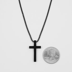 May include: A black chain necklace with a black cross pendant. The pendant is about the size of a US quarter.