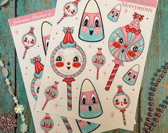 May include: Two sheets of stickers featuring whimsical candy-themed illustrations. The stickers feature candy canes, lollipops, and candy corn with cute faces. The text on the stickers reads "Johanna Parker & Spookshow Babe Designs Merrymints".