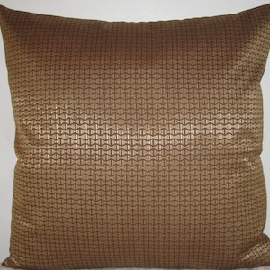 May include: A brown and gold decorative pillow with a geometric pattern.