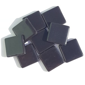 May include: A collection of glossy, square, black tiles. The tiles are arranged in a slightly overlapping pattern, with visible shadows. The edges of the tiles are smooth and rounded, reflecting light. The overall appearance is sleek and modern.