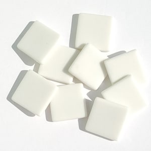 May include: A group of ten white ceramic square tiles. The tiles are smooth and have a glossy finish.