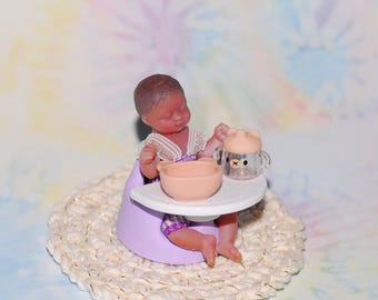 mini baby with clothing, booster seat and dishes