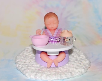 mini baby with clothing, booster seat and dishes