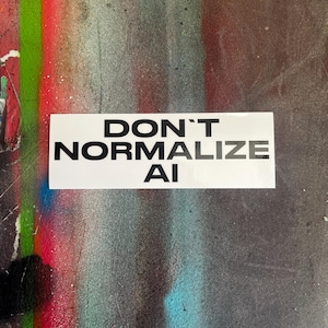 May include: A rectangular white sticker featuring the bold black text DON'T NORMALIZE AI in a clean sans-serif font. The sticker is presented as a flat, adhesive label with a high-contrast design, clearly displaying the message in three lines.