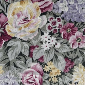 May include: A fabric featuring a dense floral pattern with large yellow and magenta roses, clusters of small purple hydrangea-like blossoms, and tiny white flowers. The design includes grey-green foliage on a light grey background throughout.