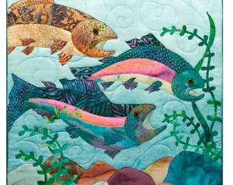May include: A quilted artwork featuring three colorful fish swimming in a light blue aquatic scene. The fish have open mouths and are surrounded by green seaweed and colorful rocks. The fish are shades of orange, pink, and teal.