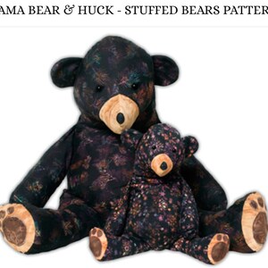May include: Two black and purple stuffed bears with floral patterns. The larger bear is sitting with its legs outstretched and the smaller bear is sitting in front of it.