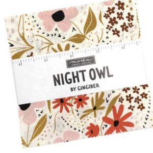 May include: A stack of fabric squares with floral patterns in pink, red, and brown on a cream background. The fabric is labeled "Night Owl" by Gingiber. The squares are held together with a white band that has a ruler printed on it.