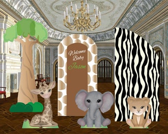 May include: A set of party decorations featuring a tall tree cutout, a giraffe cutout, a central arched backdrop with giraffe print and the text Welcome Baby Jason, a gray elephant cutout, a zebra print backdrop, and a lion cub cutout.