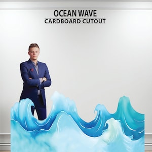May include: A cardboard cutout of ocean waves in shades of blue and turquoise. The cutout has the text "OCEAN WAVE CARDBOARD CUTOUT" at the top. A person in a blue suit stands behind the cutout.