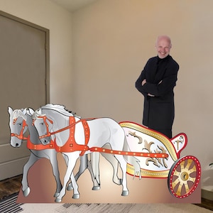 May include: A white chariot pulled by two white horses with red harnesses. The chariot has gold accents and a red and gold wheel. The chariot is on a brown background.