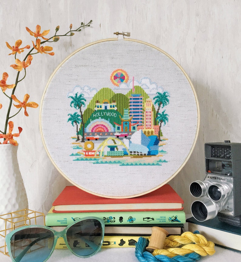 A cross stitch embroidery pattern of Los Angeles featuring famous landmarks and monuments.
