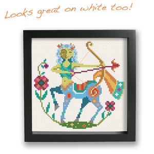 May include: A colorful cross-stitch pattern of a Sagittarius zodiac sign. The Sagittarius is depicted as a centaur with a bow and arrow, surrounded by flowers. The design is framed in a black frame.