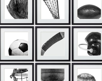 May include: Nine black framed pictures with white mats, each featuring a different sports item. The items include a baseball, basketball, football, soccer ball, hockey stick, lacrosse stick, catcher's mask, baseball glove, and a football helmet.