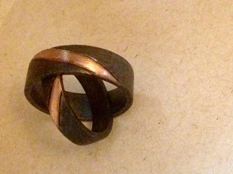 Wedding band in oxidized sterling silver with a rose gold stripe