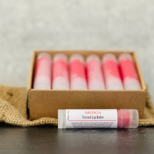 12 Arnica Lip Balm Sticks Clear or Tinted Chapsticks Unlabeled Private Label Med Spa Branded Gifts Pink Brown Red Aesthetics RedTint Arnica Balm