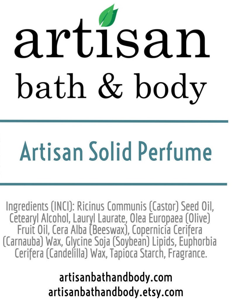 May include: Artisan Solid Perfume with a green leaf logo and the text "artisan bath & body". The ingredients are listed below: Ricinus Communis (Castor) Seed Oil, Cetearyl Alcohol, Lauryl Laurate, Olea Europaea (Olive) Fruit Oil, Cera Alba (Beeswax), Copernicia Cerifera (Carnauba) Wax, Glycine Soja (Soybean) Lipids, Euphorbia Cerifera (Candelilla) Wax, Tapioca Starch, Fragrance. The website address is artisanbathandbody.com and artisanbathandbody.etsy.com.