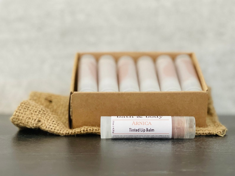12 Arnica Lip Balm Sticks Clear or Tinted Chapsticks Unlabeled Private Label Med Spa Branded Gifts Pink Brown Red Aesthetics BrownTint ArnicaBalm