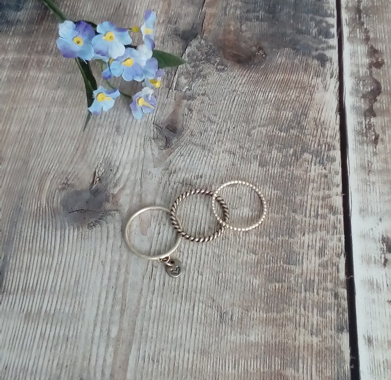 Custom hand stamped silver stacking ring with symbol or initial. Sterling silver personalised ring with charm