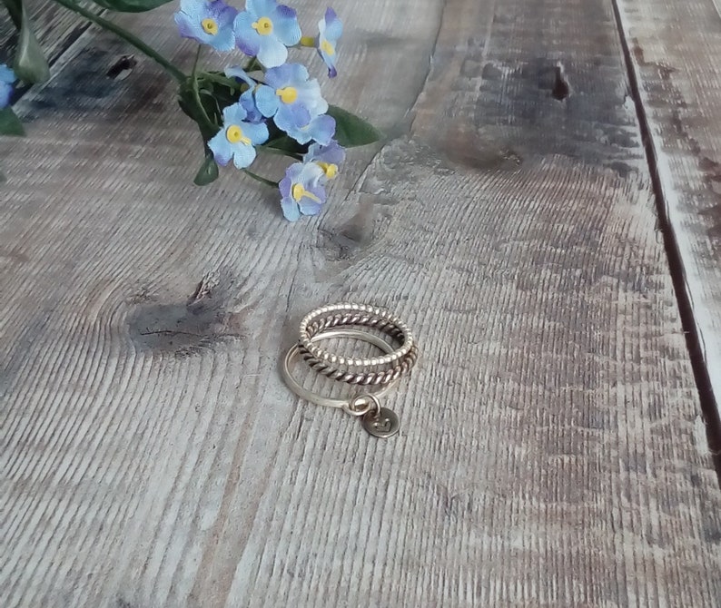 Custom hand stamped silver stacking ring with symbol or initial. Sterling silver personalised ring with charm