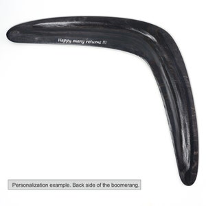 May include: Black wooden boomerang with the text "Happy many returns!!!" engraved on the back side.