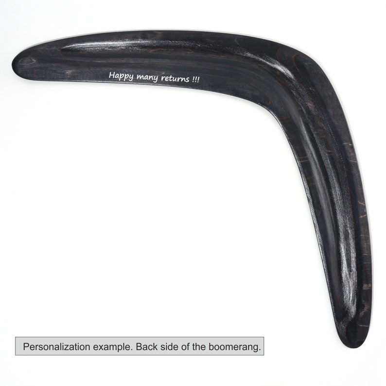 May include: Black wooden boomerang with the text "Happy many returns!!!" engraved on the back side.