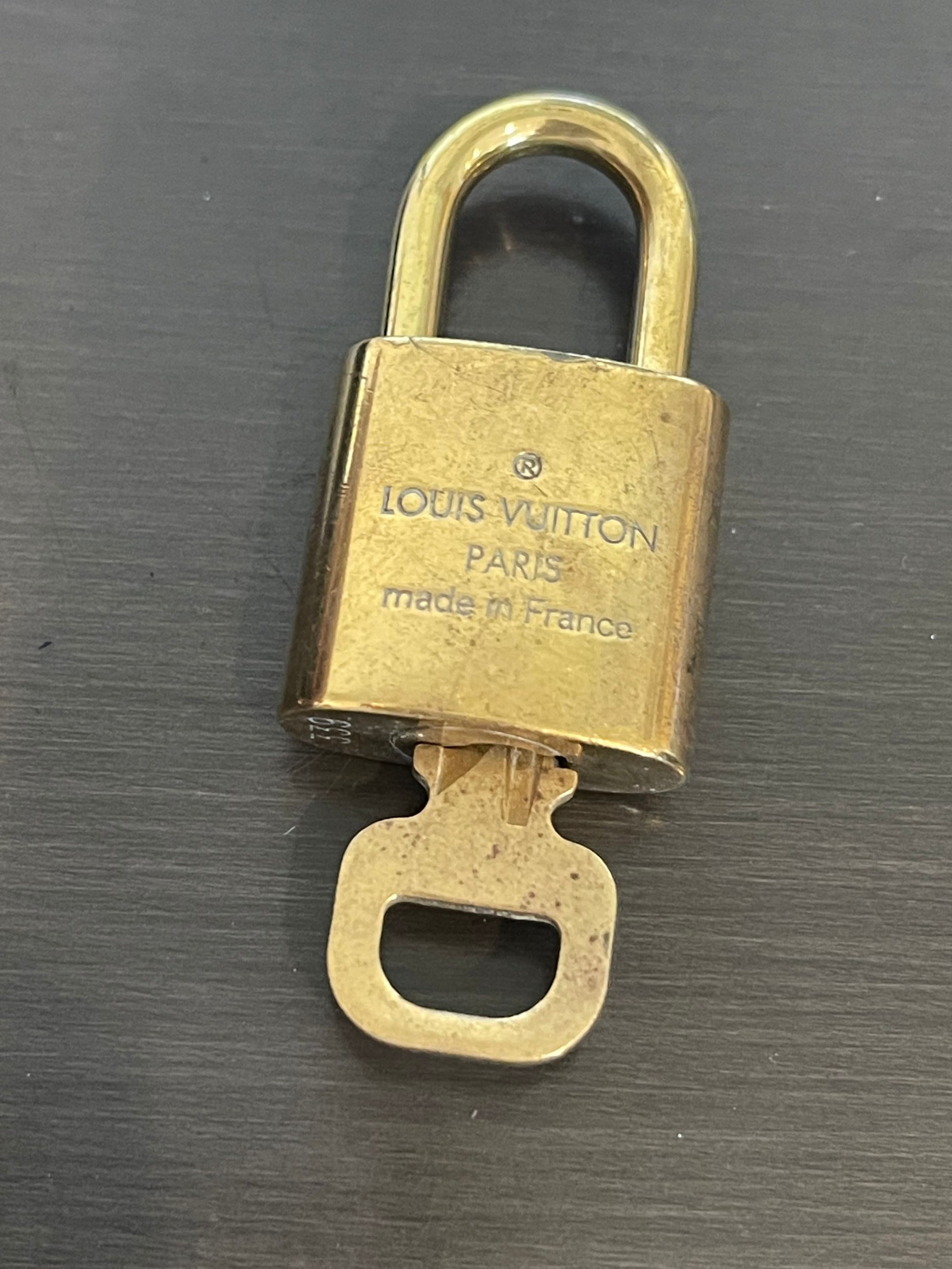 Lot 999 - Two Louis Vuitton lock and keys.