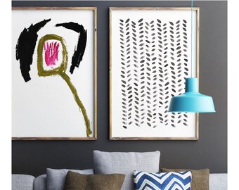 May include: A modern living room with a gray sofa, decorative pillows, and abstract art in wooden frames. A turquoise pendant lamp hangs above a white coffee table with a black metal bowl and candle holders.