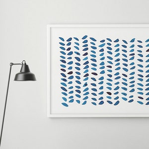 May include: A framed abstract art print featuring a pattern of blue leaf-like shapes on a white background. The artwork is displayed above a gray upholstered bench with a dark wooden frame. A black floor lamp stands to the left.