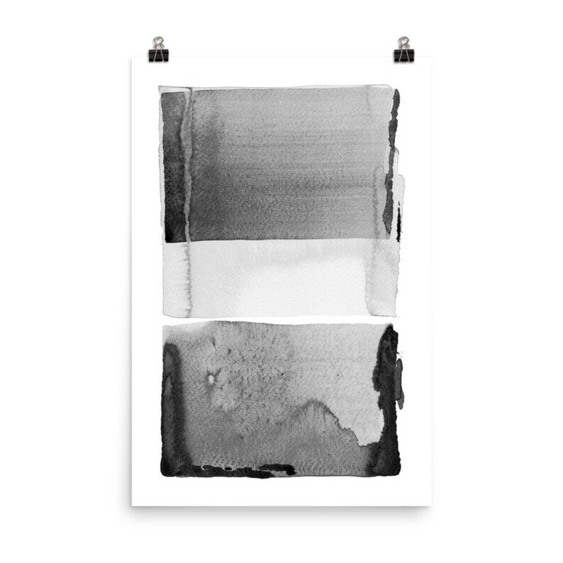 May include: Abstract watercolor art print featuring layered rectangular shapes in shades of gray and white. The artwork is mounted on white paper and held by two black binder clips. The design has a modern, minimalist aesthetic.