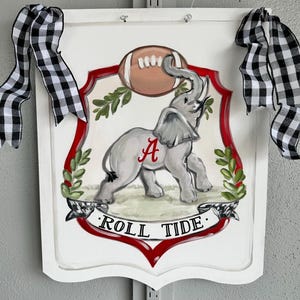 Elephant Crest Door Hanger, customize color and team. Size is 18”x24”.