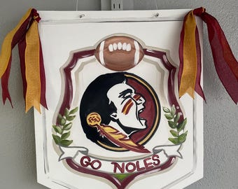 Warrior Crest Door Hanger, customize color and team. Size is 18”x24”.