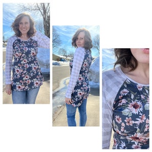 K&ouml;nnte beinhalten: Ein lang&auml;rmliges Shirt mit Blumenmuster und einem wei&szlig;en und grauen Karomuster an den &Auml;rmeln. Das Shirt hat einen runden Ausschnitt und eine lockere Passform.