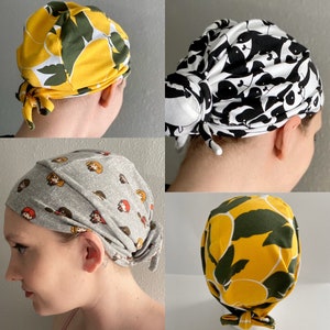 May include: Four different styles of fabric head coverings. The first is yellow with green leaves, the second is black and white with a panda pattern, the third is gray with cartoon characters, and the fourth is yellow with green leaves.