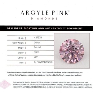 May include: A round, pink diamond with a carat weight of 0.14ct, displayed on a gem identification document. The document includes details such as clarity, color, and the date of assessment, November 18, 2019. The diamond is from Argyle Pink Diamonds.