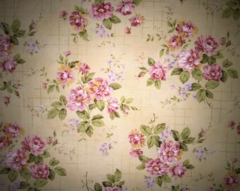May include: A fabric design with a repeating pattern of pink and purple roses, green leaves, and small purple flowers. The background is a pale yellow with a subtle grid, giving a vintage feel.
