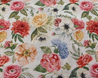 May include: Fabric with a floral pattern in a watercolour style. The design showcases a variety of flowers in shades of red, pink, yellow, and orange, with green foliage. The background is a light, textured off-white.