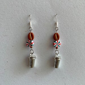 May include: A pair of silver dangle earrings with a coffee cup charm, a peppermint candy bead, and a coffee bean bead.