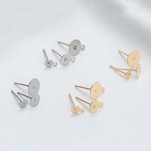 May include: A set of earring findings with a variety of sizes and finishes. The findings are made of metal and have a loop at the top for attaching earrings. The findings are available in silver and gold.