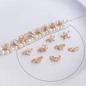 14K vergulde CZ micropave dubbele streng afstandkralen: bloem, vlinder, waaier